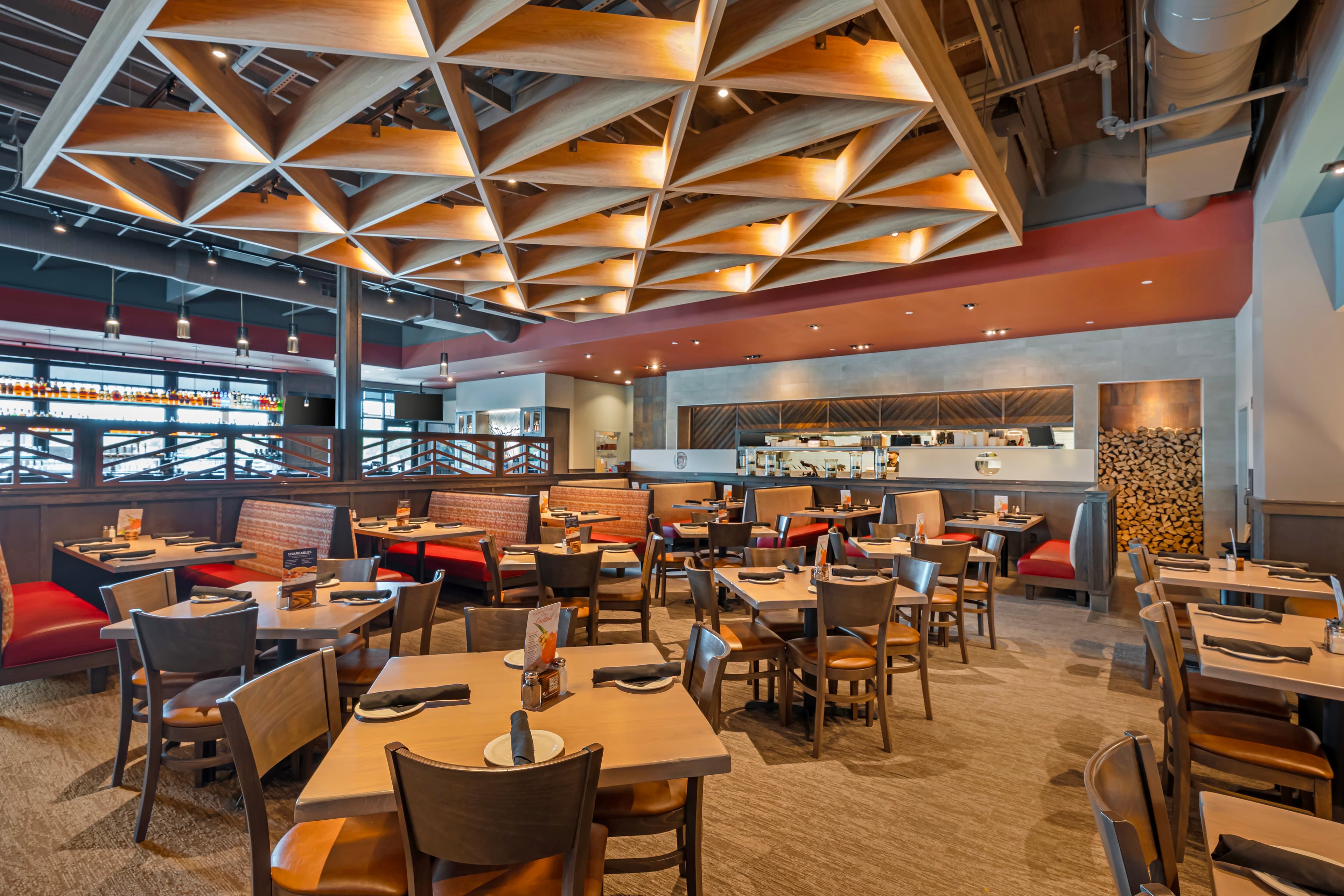 Tables, booths and an open kitchen inside Firebirds at Norterra