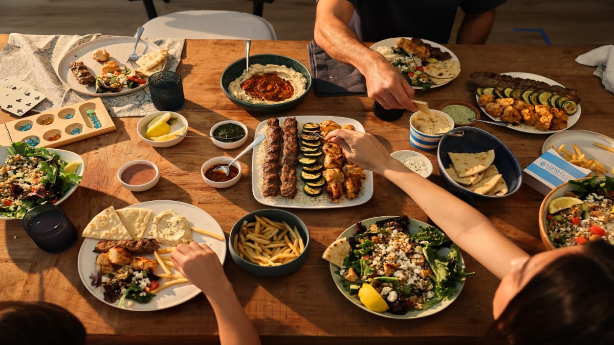 Luna Grill kebabs, hummus, salads and pita shared around a table