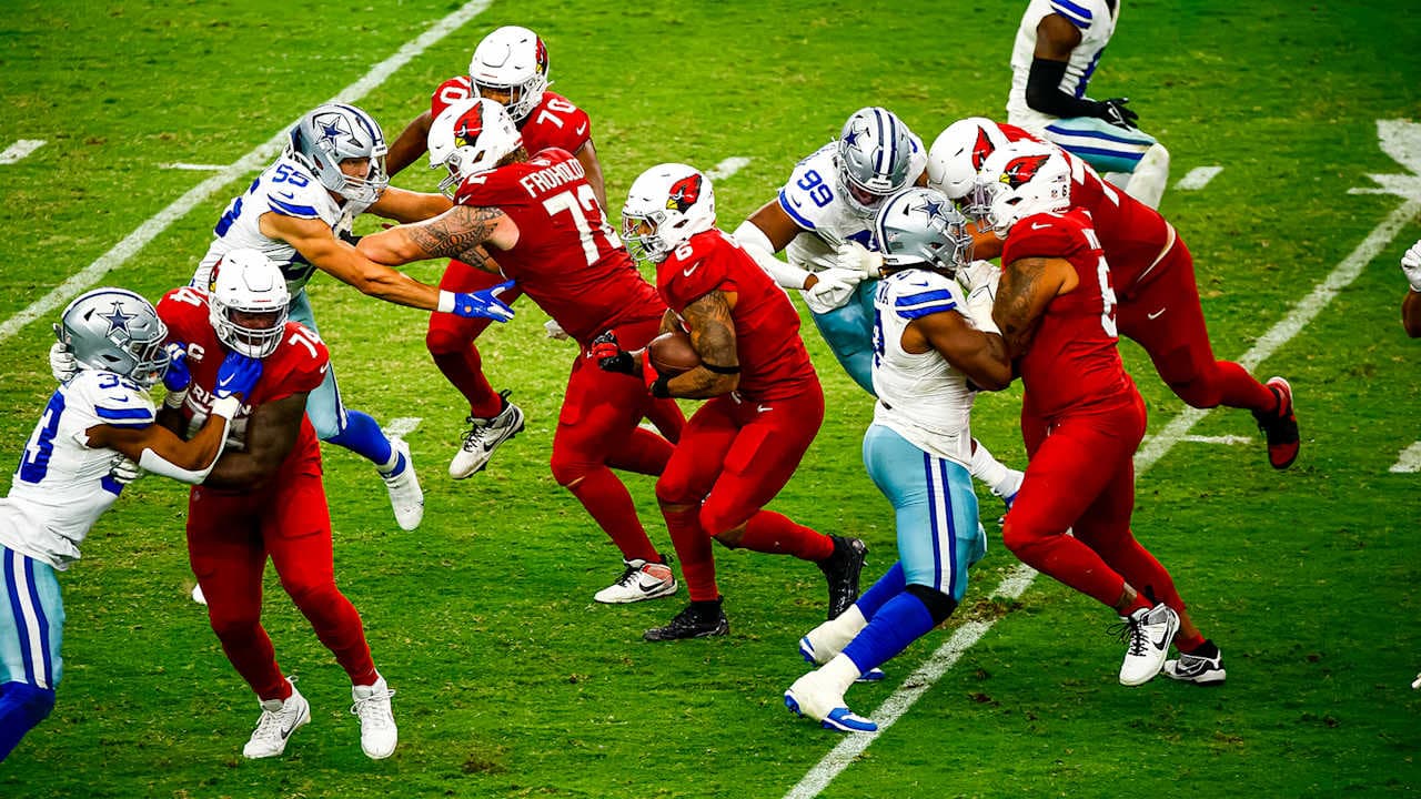 Arizona Cardinals and Dallas Cowboys players on the field